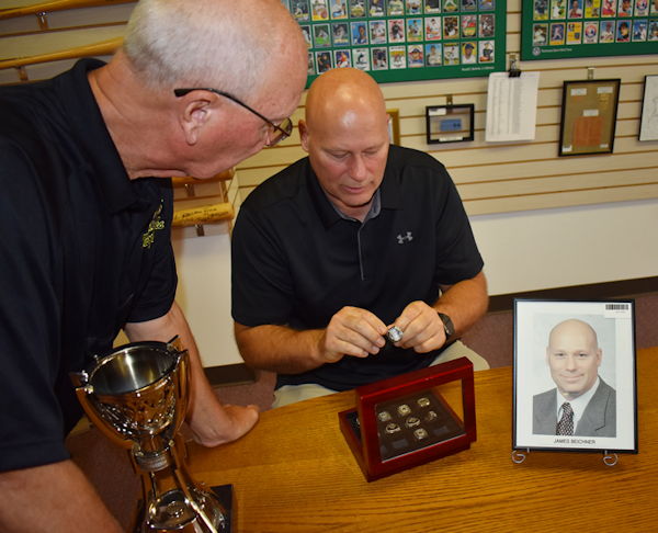 Jim Beichner with Randy Anderson looking at his rings.