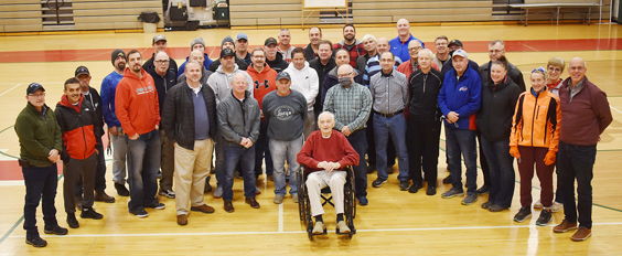 MacTavish is surrounded by his officiating peers.