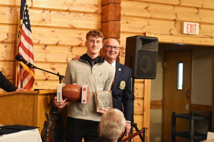 Fredonia’s Ethan Fry is honored by Randy Anderson.