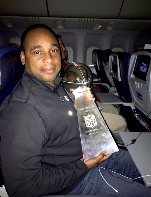 David Hinson holds the Lombardi Trophy.