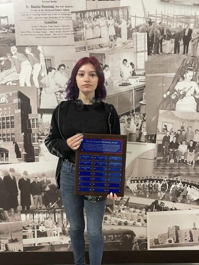 Brooklyn Pryll poses with award plaque.