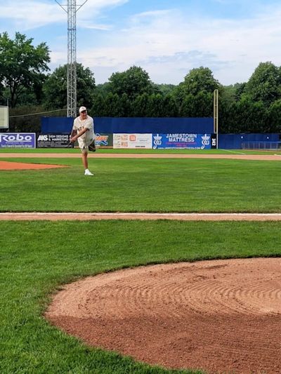 Tom Brown throws the first pitch.