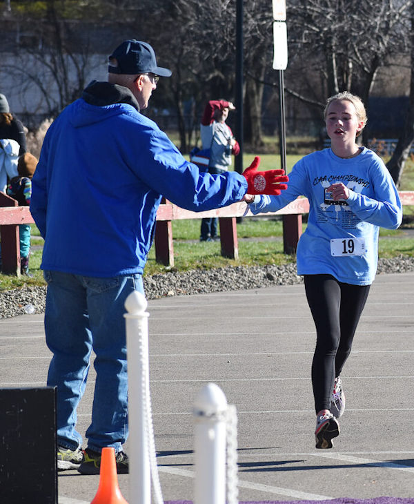Lucy Brown of Lakewood is congratulated by Tom Priester.