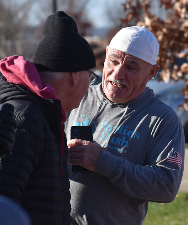 Race director Tom Anderson, left, chats with Paul Veneto.