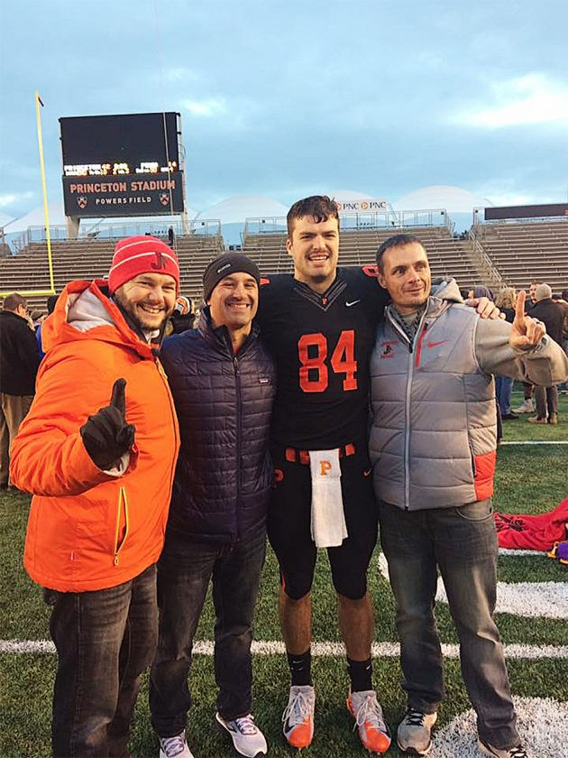 Stephen Carlson (84) celebrates with his former Jamestown High School coaches following Princeton’s season-ending victory last November. From the left are Richie Joly, Tom Langworthy and Ryan Calkins.