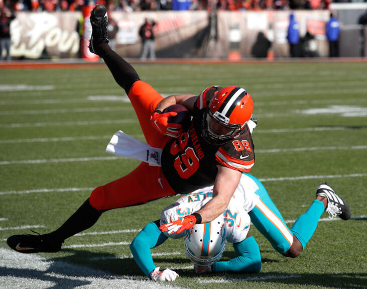 Cleveland Browns tight end Stephen Carlson is tackled after making a catch against the Miami Dolphins.
