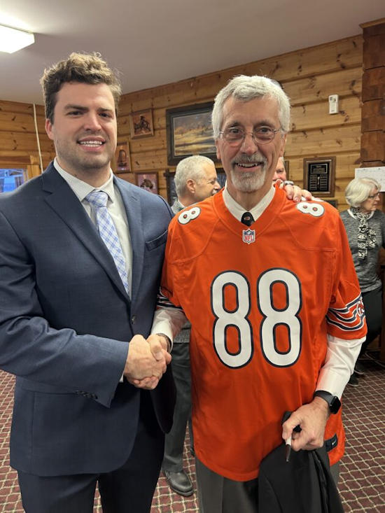 Stephen Carlson, left, shakes hands with Paul Hedin.