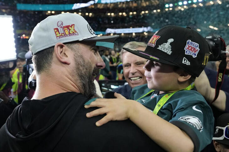 Philadelphia Eagles head coach Nick Sirianni celebrates with his son Miles after the NFL Super Bowl.