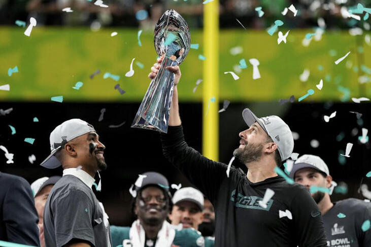 Jamestown native and Philadelphia Eagles head coach Nick Sirianni, right, lifts the Vince Lombardi Trophy next to quarterback Jalen Hurts.