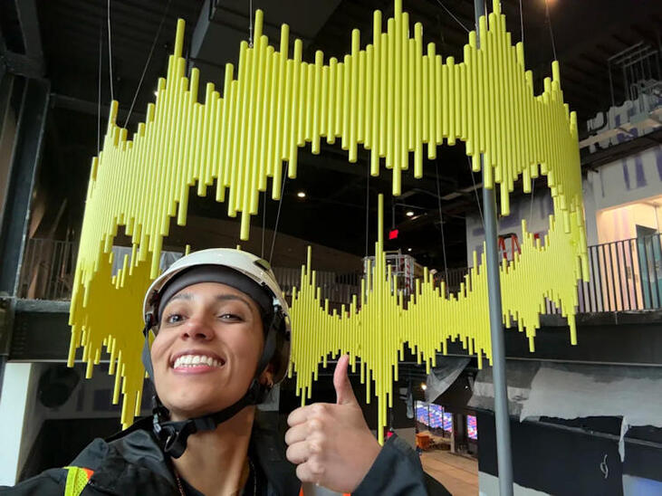 Jamestown native Olivia Reinhardt gives a thumbs-up to the circular sound wave.