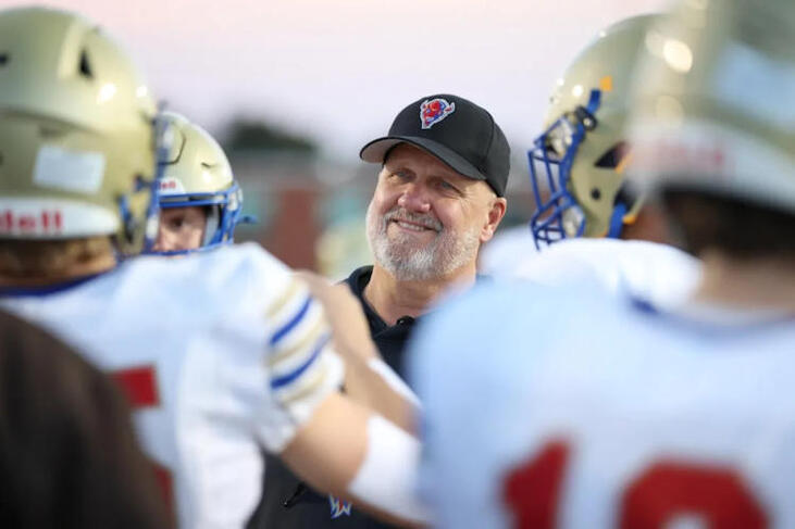 Maple Grove head football coach Curt Fischer talks with his team.