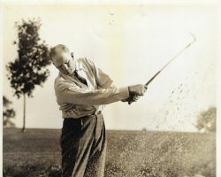Howard Ehmke golfing from sand trap.