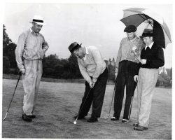 Howard Ehmke holding umbrella.