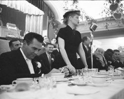 Temple Hesed Abraham Sports Night, Monday, February 6, 1956, Jim McCusker, far right, seated next to Jackie Robinson, listens to Jamestown native, Lucille Ball, address the crowd. Her husband, Desi Arnaz, is on far left.