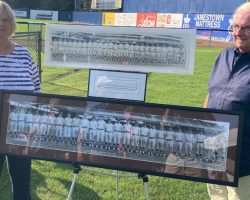Linda and Dennis Erickson, Swat Erickson's grandchildren, pose with a panoramic photo of the 1922 Washington Senators baseball team that Swat played on.