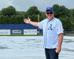 Bob Rosania, the owner of Ehmke Manufacturing Co., Philadelphia, admires the tarp used to cover the infield after a rain storm on Howard Ehmke Day at Diethrick Park.