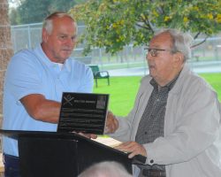 Town of Ellery supervisor Arden Johnson, right, presents a plaque to Tom Brown, son of the late Walt Brown. The town is dedicating a Little League field in the name of Walt, a Bemus Point native and former major league pitcher. October 2018.P-J photo by Scott Kindberg Town of Ellery supervisor Arden Johnson, right, presents a plaque to Tom Brown, son of the late Walt Brown. October 2018.