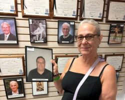 Leslie Meszaros Berg holds her father's photo at the CSHOF on September 14, 2026. Leslie Meszaros Berg holds her father's photo.