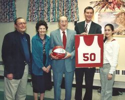 From left, former JHS varsity basketball coach John "Dutch" Leonard, parents
Greta and Don Johnston, Donn Johnston and his daughter Kate celebrate the retirement of Donn's jersey number in 1999. The retirement of Donn's jersey number in 1999.