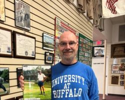 Michael Englert holds his father's photo at the CSHOF.