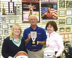 CSHOF president Randy Anderson is flanked by Wendy Lewellen, left, and Nancy Bargar as they show off some of the memorabilia that Stanford University women's basketball coach Tara VanDerveer donated to the hall. Among the items is an autographed program from the Naismith Memorial Basketball Hall of Fame.