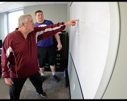 Former NFL coach Bob Palcic quizzes K-State's B.J. Finney about blocking schemes at Simoneau Sports Performance in Overland Park, Kansas on February 10, 2015 during preparations for the NFL Scouting Combine.
