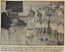Clymer coach Ed Bailey presents Amy King with a game ball for reaching the  1000 point mark.