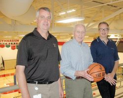 Jim McElrath (Mac )(center) is shown with his sons Mike (left) and Jim at the JHS gymnasium that is named after him in this 2013 photo.
