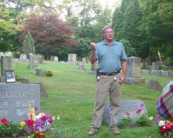 Mel Feather at his brother Dan Feather's gravesite.