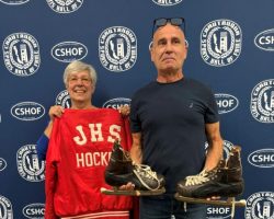 Mindy James and Greg Alm, John's daughter and son, visited the CSHOF to donate their father's coaching jacket and ice skates, September 28, 2026. Mindy James and Greg Alm, John's daughter and son, visited the CSHOF.