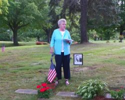 Sally Corkery at her father Clayt Webeck's gravesite.