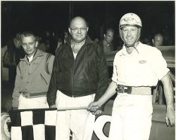 Left to right, mechanic Jim Fardink, owner Julian Buesink, and driver Freddy Knapp after a win at Stateline on July 30, 1966. Left to right, mechanic Jim Fardink, owner Julian Buesink, and driver Freddy Knapp after a win at Stateline on July 30, 1966.