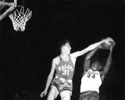 Clem Worosz blocks the shot attempt of Syracuse's Jim Brown during the 1950s.