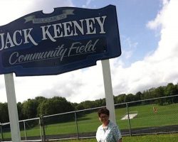 Jack Keeney's widow, Mary, standing by the sign for Jack's field in Panama. Jack Keeney's widow, Mary, standing by the sign for Jack's field in Panama.